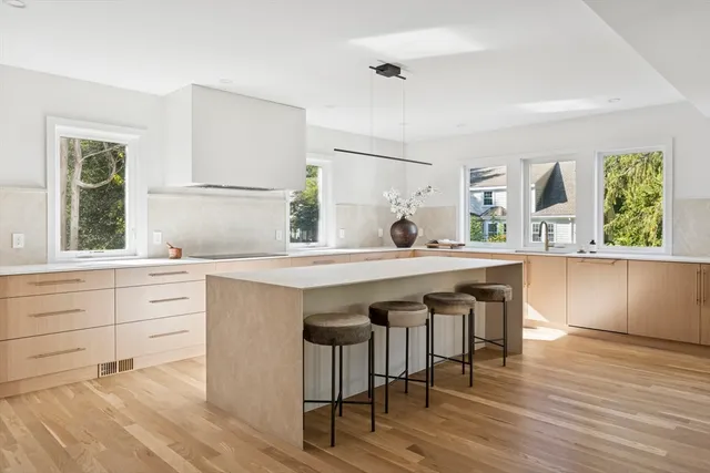 a kitchen with a wooden floor and white cabinets