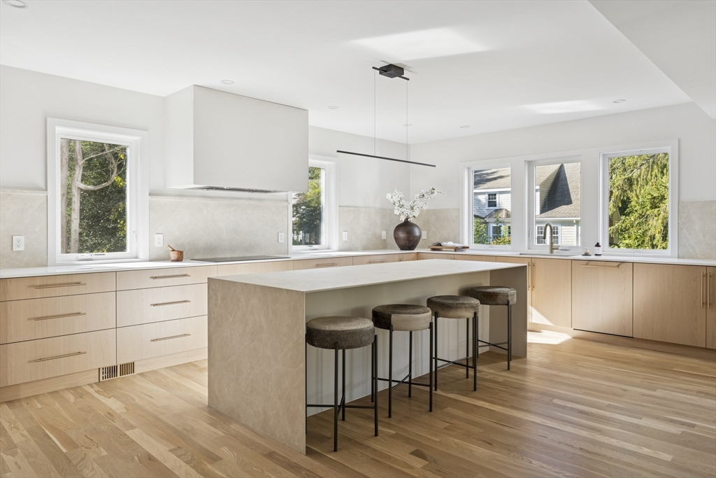 873 Chestnut Street Newton, MA 02468 - Photo 8 of 22 a kitchen with a wooden floor and white cabinets