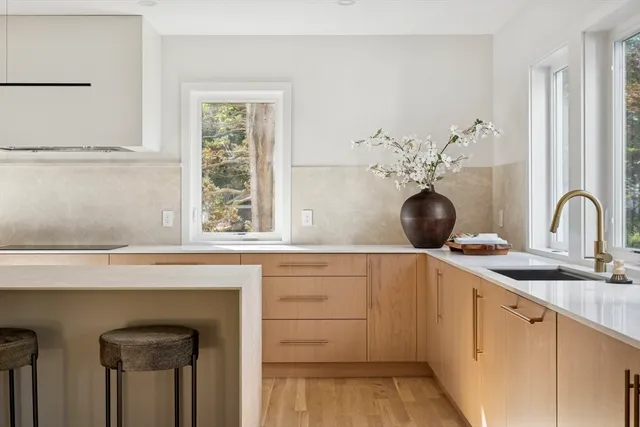 a kitchen with a sink and white cabinets