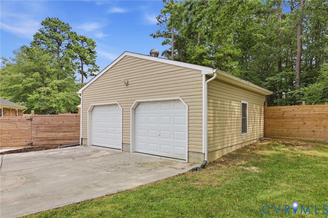3221 Clintwood Road Midlothian, VA 23112 - Photo 39 of 46 Two-car garage with tan siding, dual white paneled
