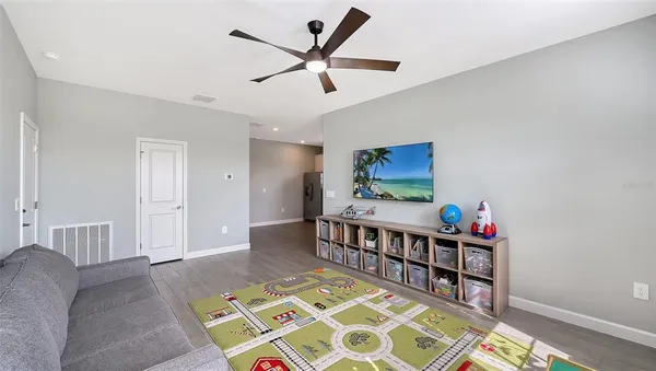 a bed room with a bed and a ceiling fan