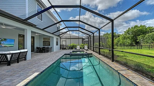 an aerial view of a house with a swimming pool yard and outdoor seating