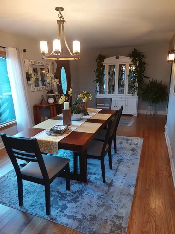 a dining room with furniture and wooden floor