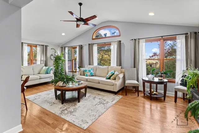 a living room with furniture a table and a large window