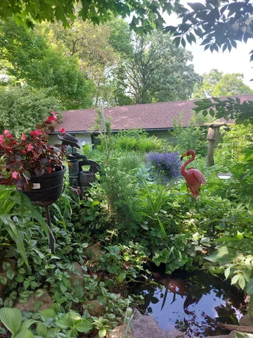 a view of a lake in front of house with yard
