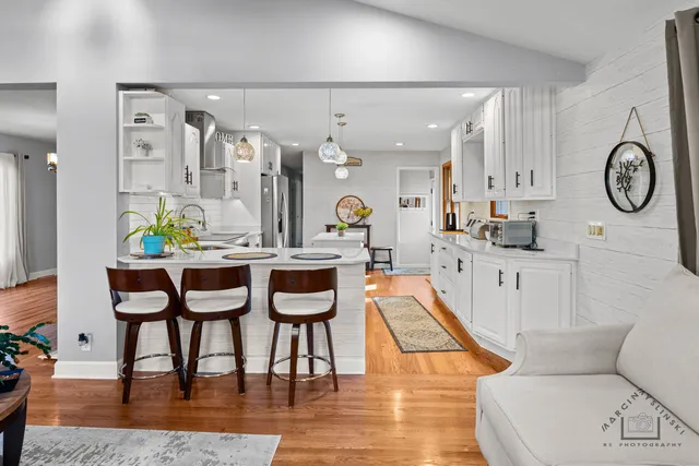 a living room with furniture a rug and white walls