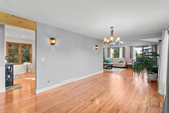 a view of a livingroom with furniture wooden floor and a chandelier