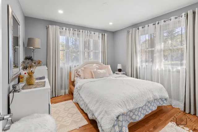 a bedroom with a bed and a large mirror