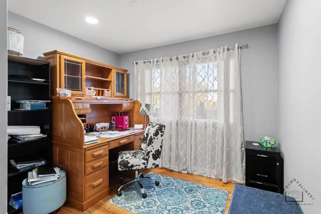 a view of a workspace with furniture and a window