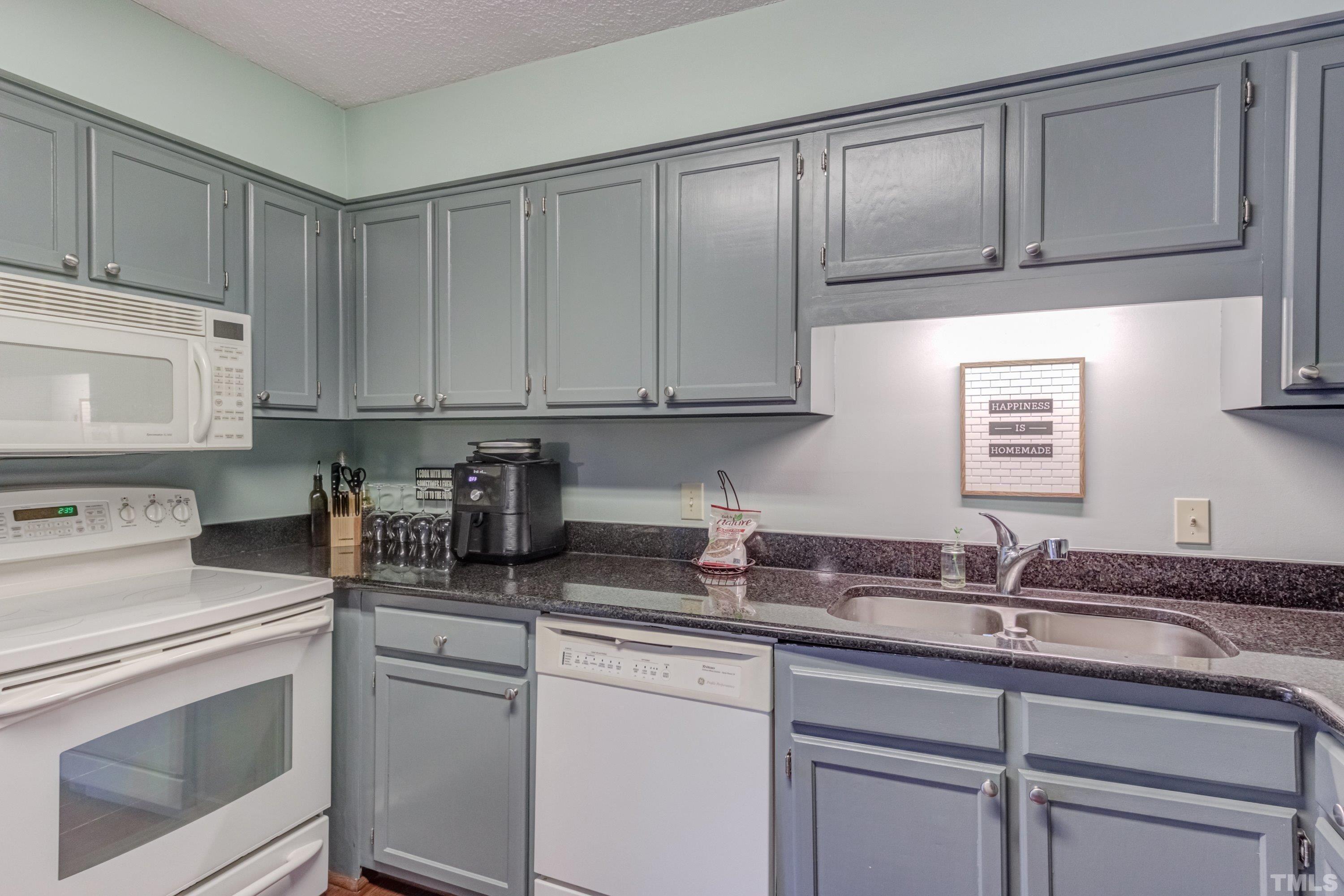 6806 Ray Road Raleigh, NC 27613 - Photo 11 of 32 a kitchen with sink cabinets and stainless steel appliances