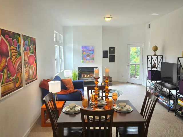a living room with fireplace furniture and a flat screen tv