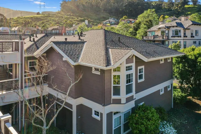 a aerial view of a house with a yard and potted plants