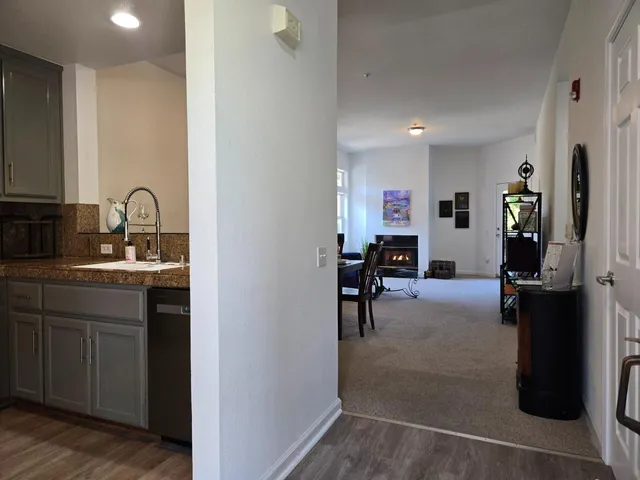 a kitchen with refrigerator and cabinets