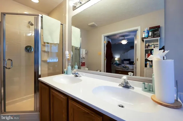 a bathroom with a sink double vanity and a mirror