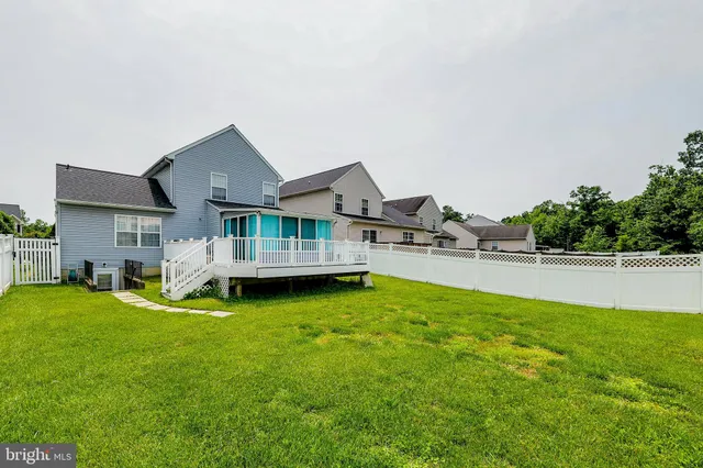 a view of a house with swimming pool and sitting area