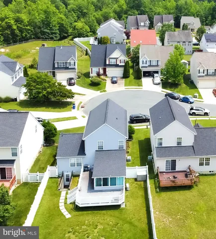 an aerial view of a house with swimming pool garden and patio