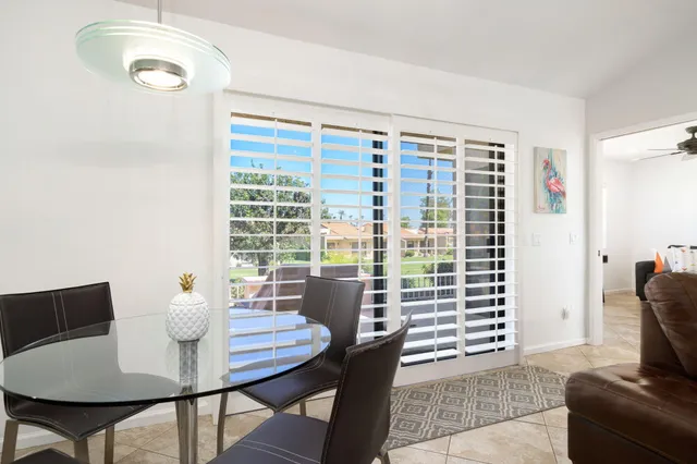 a view of a dining room with furniture and a window