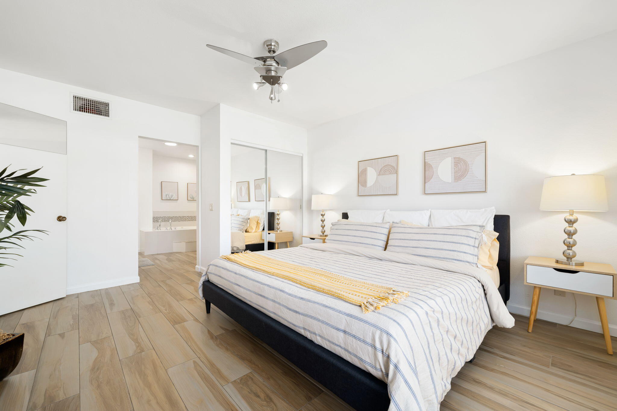 40960 La Costa Circle West Palm Desert, CA 92211 - Photo 20 of 45 a spacious bedroom with a bed and a chandelier