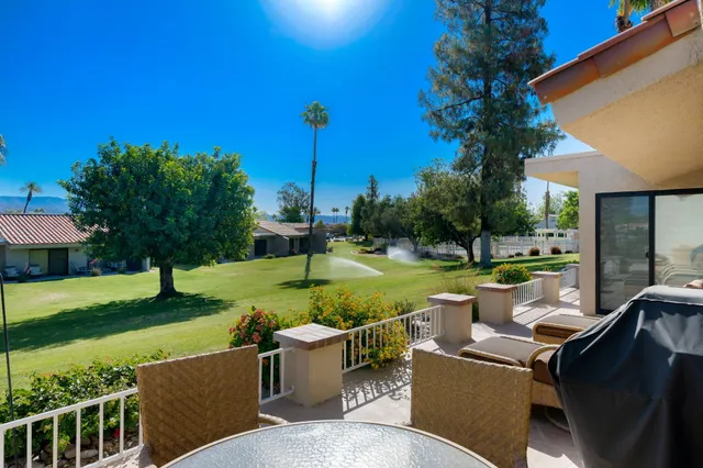a view of a deck and yard with green space