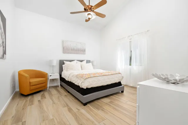 a bedroom with a bed and window