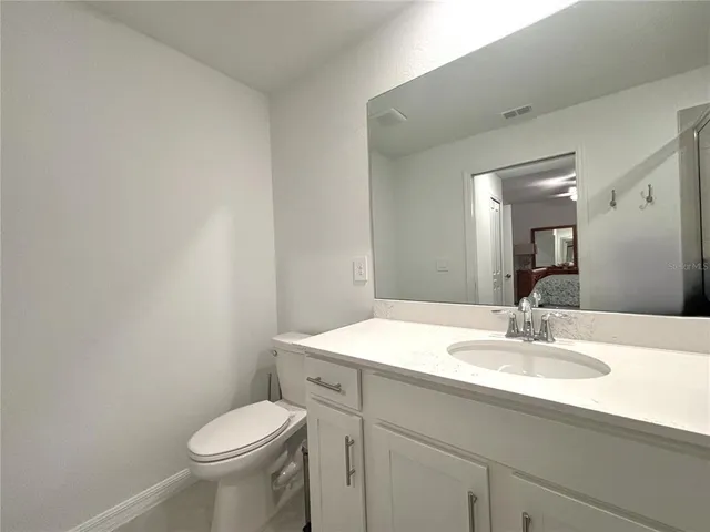 a bathroom with a sink toilet and a mirror