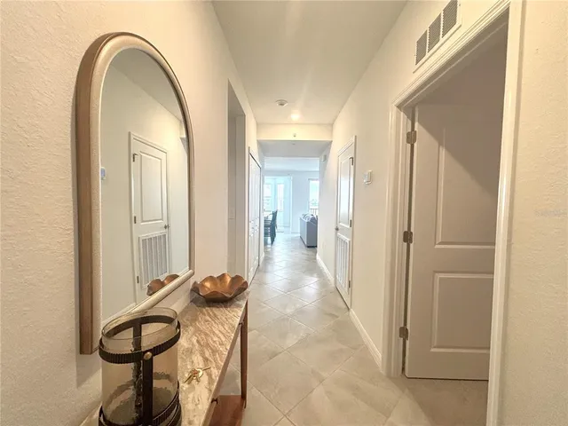 a view of a hallway with entryway wooden floor and front door