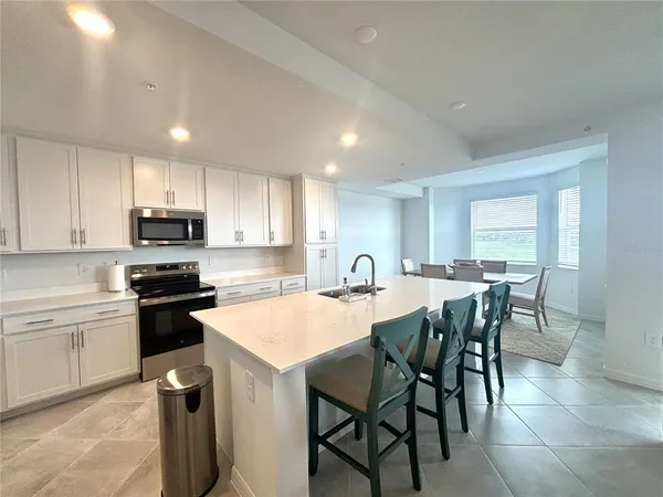 a kitchen with a table and chairs in it