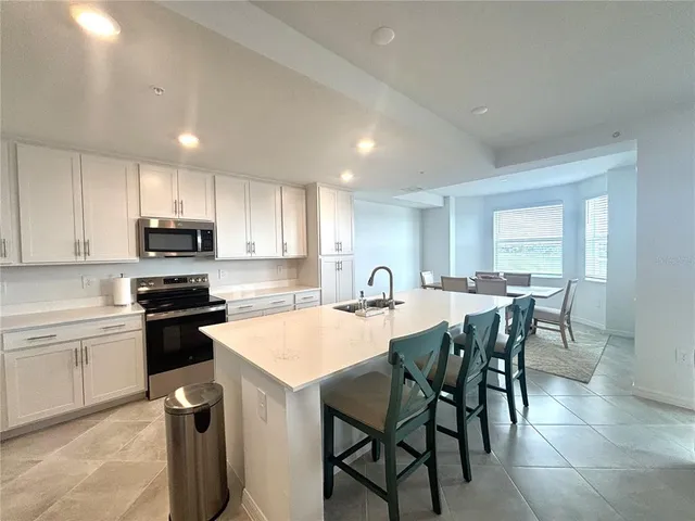 a kitchen with a table and chairs in it