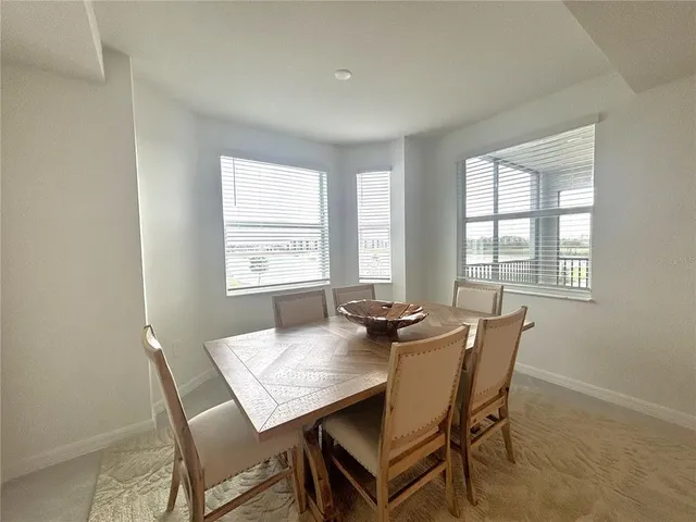 a view of a dining room with furniture and window