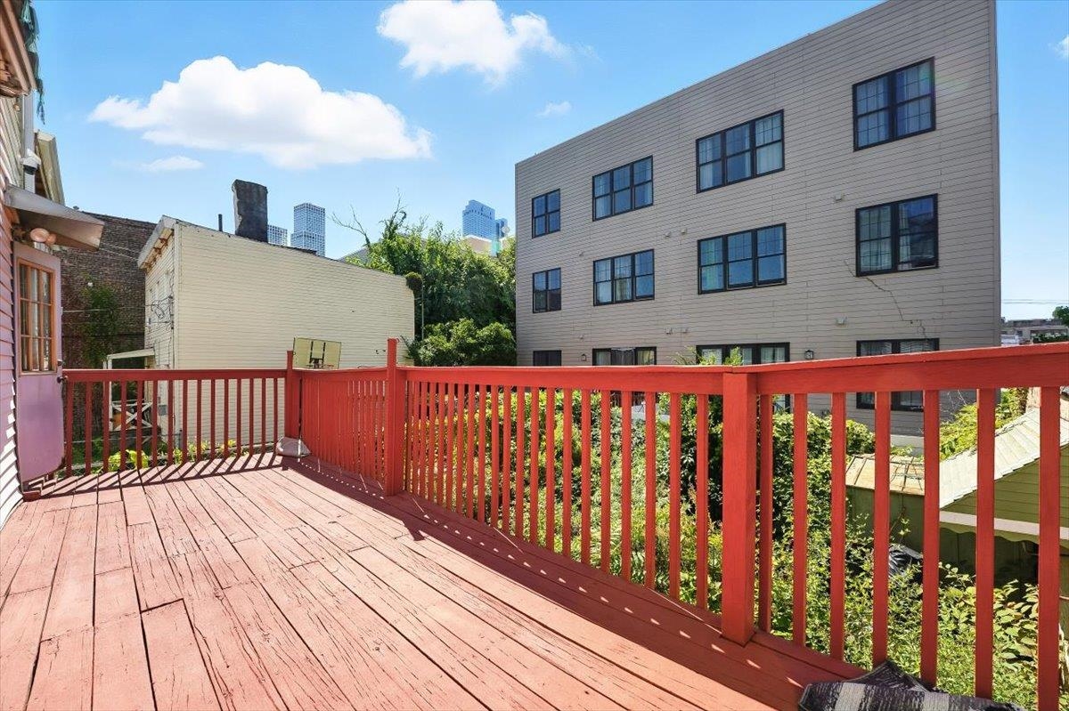 175 Van Winkle Avenue, Unit 1 Jersey City, NJ 07306 - Photo 13 of 14 a view of wooden balcony with a potted plant