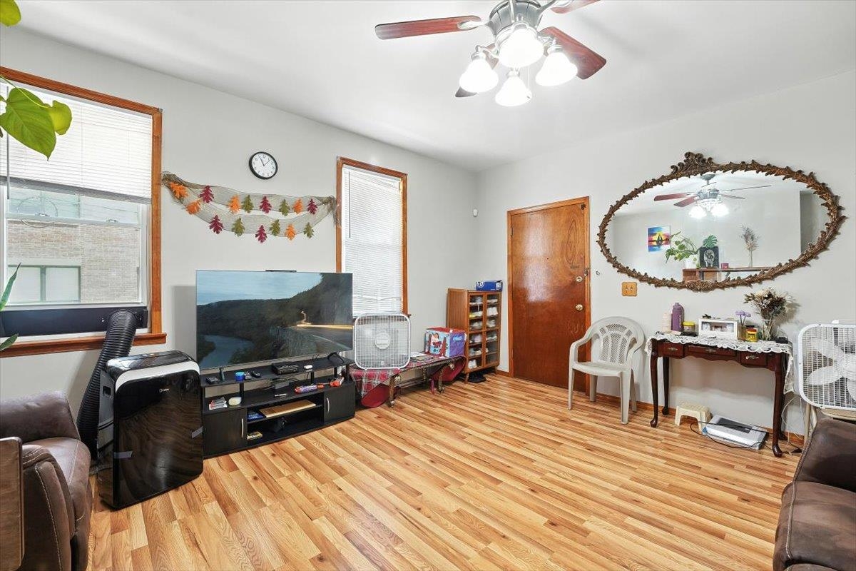 175 Van Winkle Avenue, Unit 1 Jersey City, NJ 07306 - Photo 3 of 14 a bedroom with a bed and a chandelier