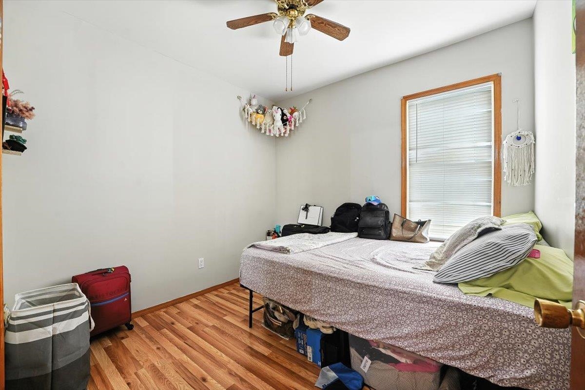 175 Van Winkle Avenue, Unit 1 Jersey City, NJ 07306 - Photo 8 of 14 a bedroom with a bed and a chandelier