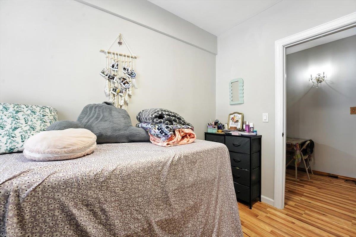 175 Van Winkle Avenue, Unit 1 Jersey City, NJ 07306 - Photo 9 of 14 a bedroom with two beds and a potted plant