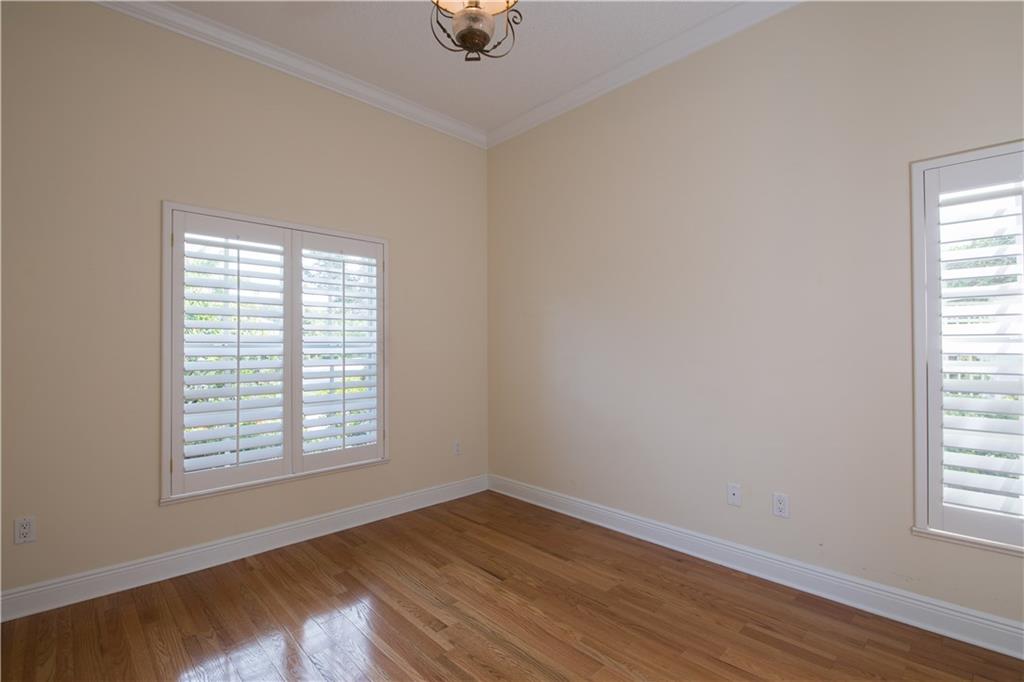 2174 Northwest Plumbago Trail Stuart, FL 34994 - Photo 17 of 26 an empty room with wooden floor and windows