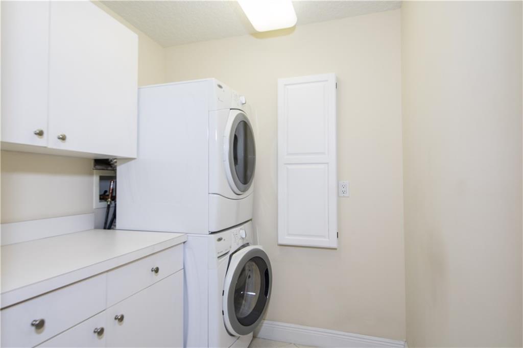 2174 Northwest Plumbago Trail Stuart, FL 34994 - Photo 18 of 26 a utility room with dryer and washer
