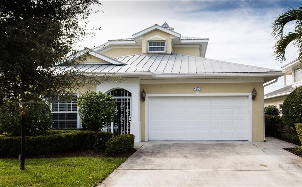 2174 Northwest Plumbago Trail Stuart, FL 34994 - Photo 19 of 26 a front view of a house with garden