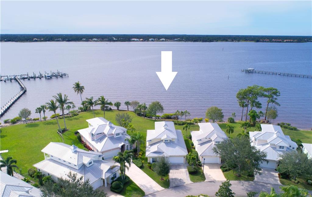 2174 Northwest Plumbago Trail Stuart, FL 34994 - Photo 2 of 26 an aerial view of a house with a garden and lake view