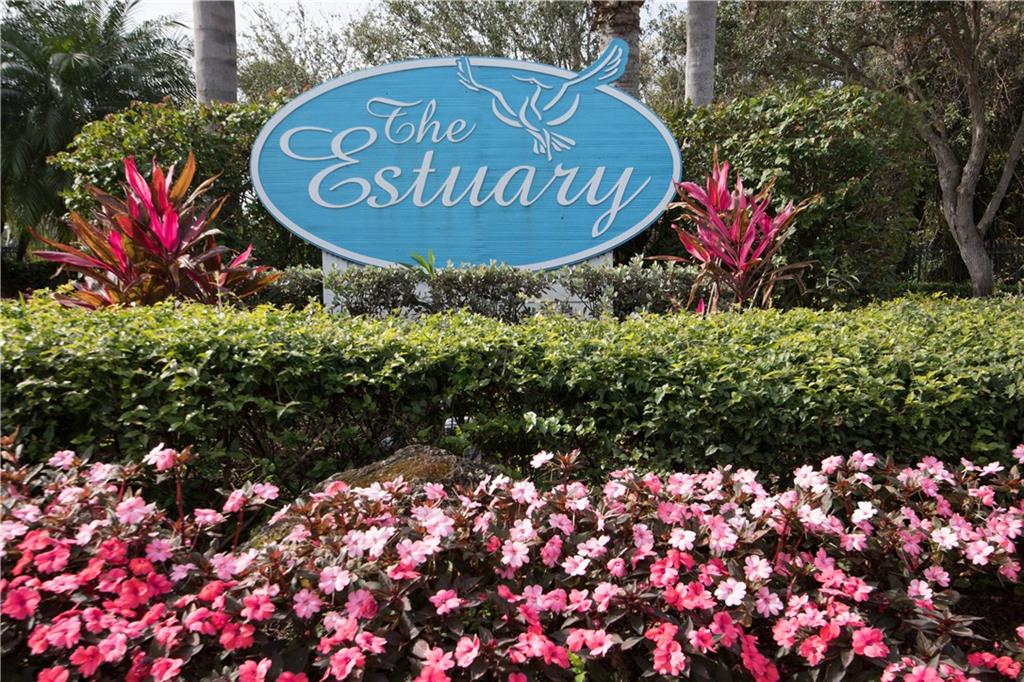 2174 Northwest Plumbago Trail Stuart, FL 34994 - Photo 23 of 26 a sign that is sitting in front of flowers