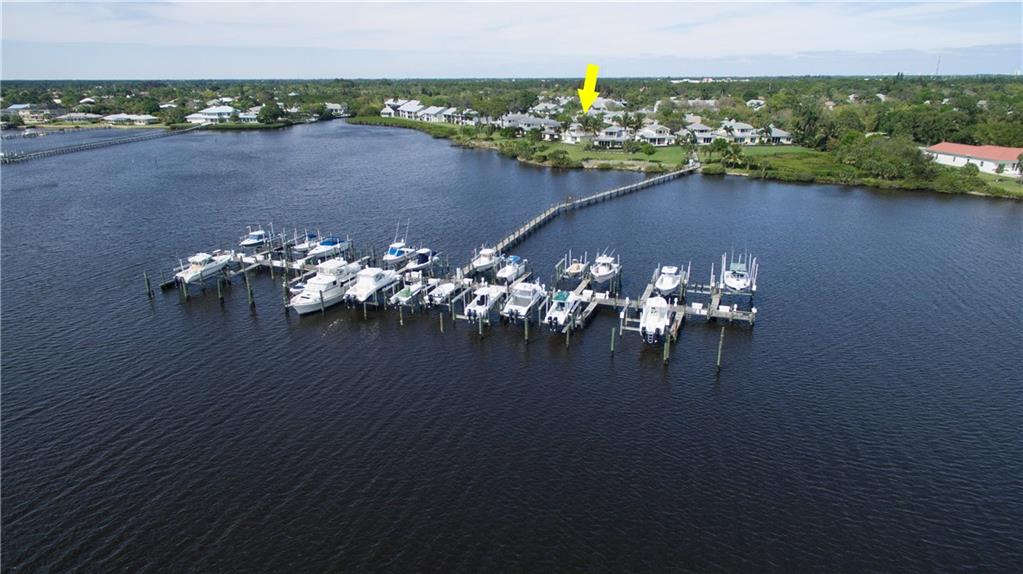 2174 Northwest Plumbago Trail Stuart, FL 34994 - Photo 4 of 26 a view of a lake with a table and chairs in roof deck