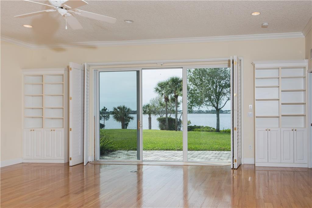 2174 Northwest Plumbago Trail Stuart, FL 34994 - Photo 7 of 26 an empty room with wooden floor and windows