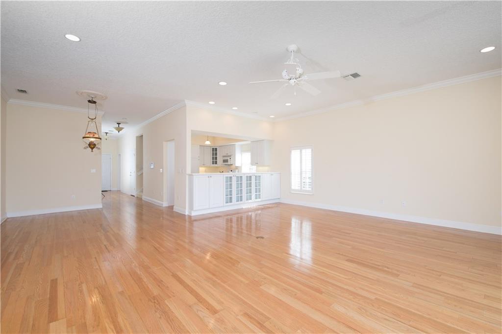 2174 Northwest Plumbago Trail Stuart, FL 34994 - Photo 8 of 26 a view of a kitchen with wooden floor and a window