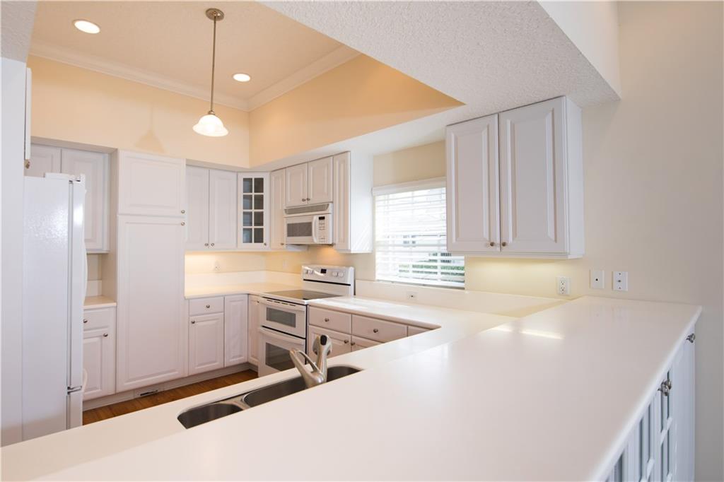2174 Northwest Plumbago Trail Stuart, FL 34994 - Photo 10 of 26 a view of a kitchen with a sink a cabinets and window