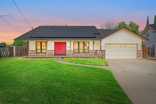 a front view of house with yard and outdoor seating