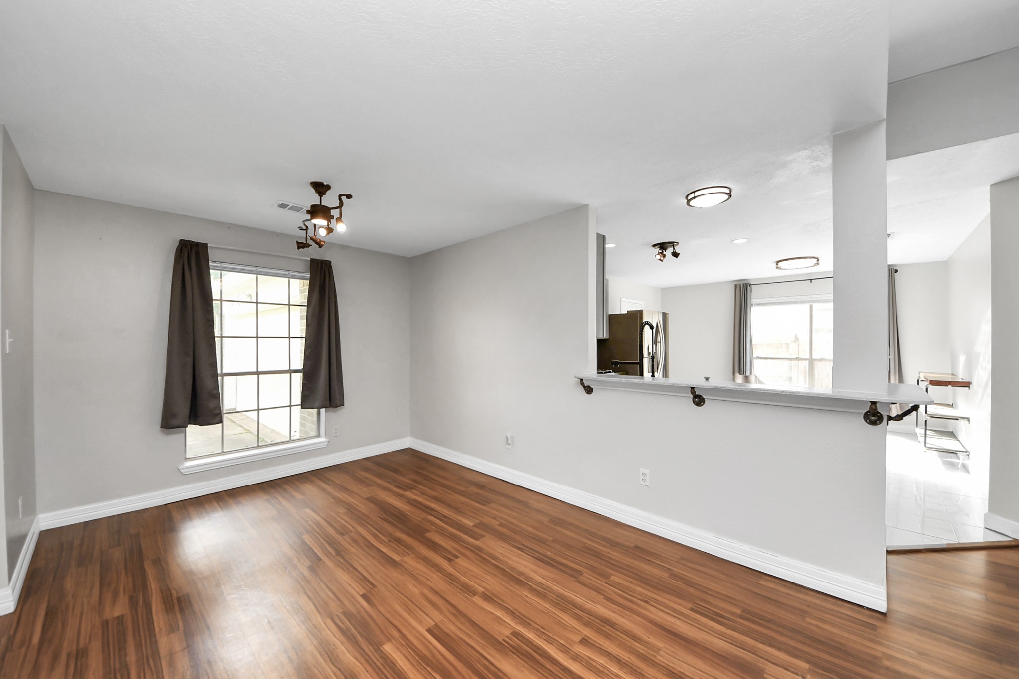 28707 Stapleford Street Spring, TX 77386 - Photo 5 of 38 a view of an empty room with wooden floor and a window
