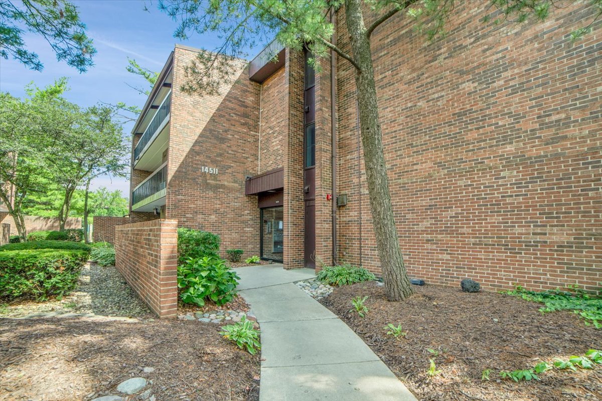 14511 Central Court, Unit M2 Oak Forest, IL 60452 - Photo 1 of 38 a brick building with a sink and yard next to a road