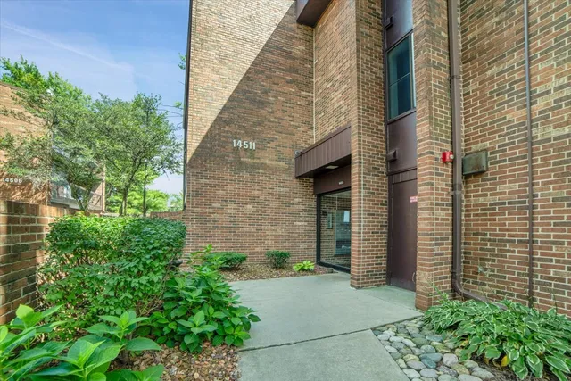 a pathway of a house with potted plants