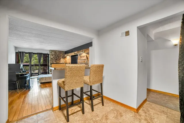 a dining room with furniture and wooden floor
