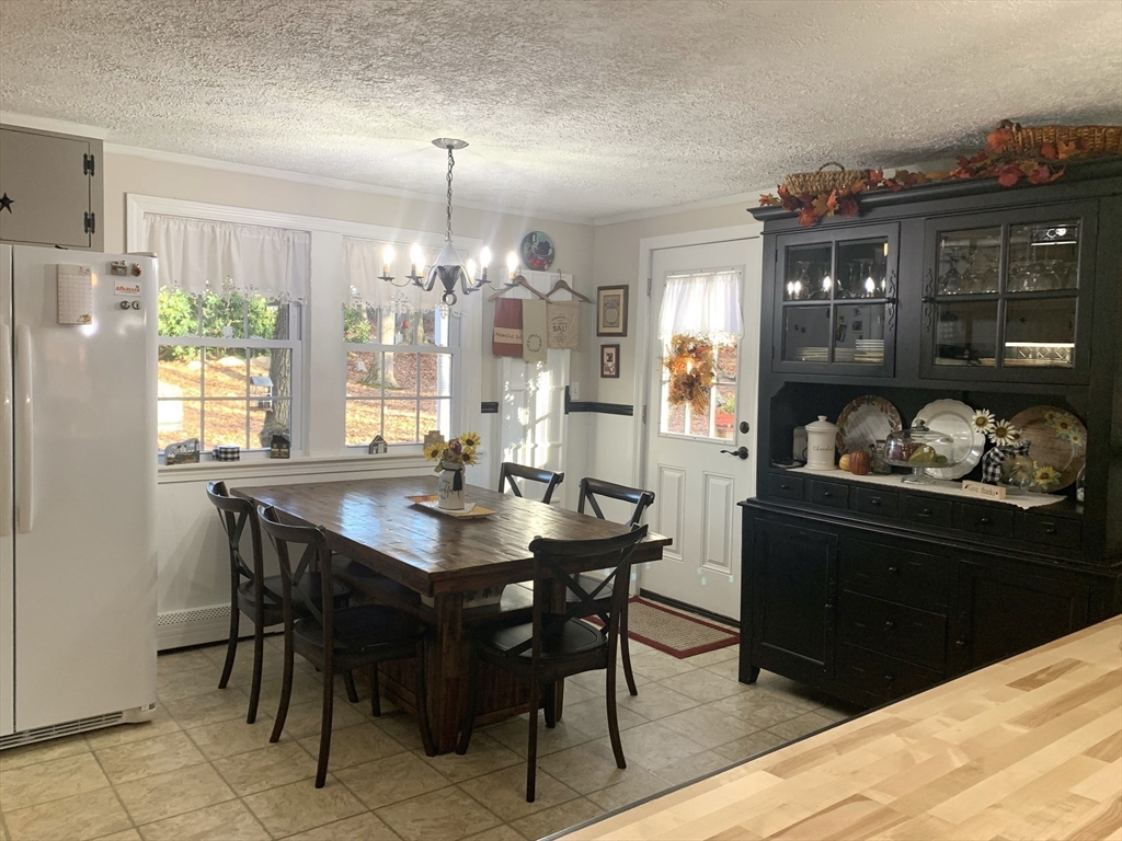 21 Sullivan Road Charlton, MA 01507 - Photo 8 of 35 a kitchen with a table and chairs in it
