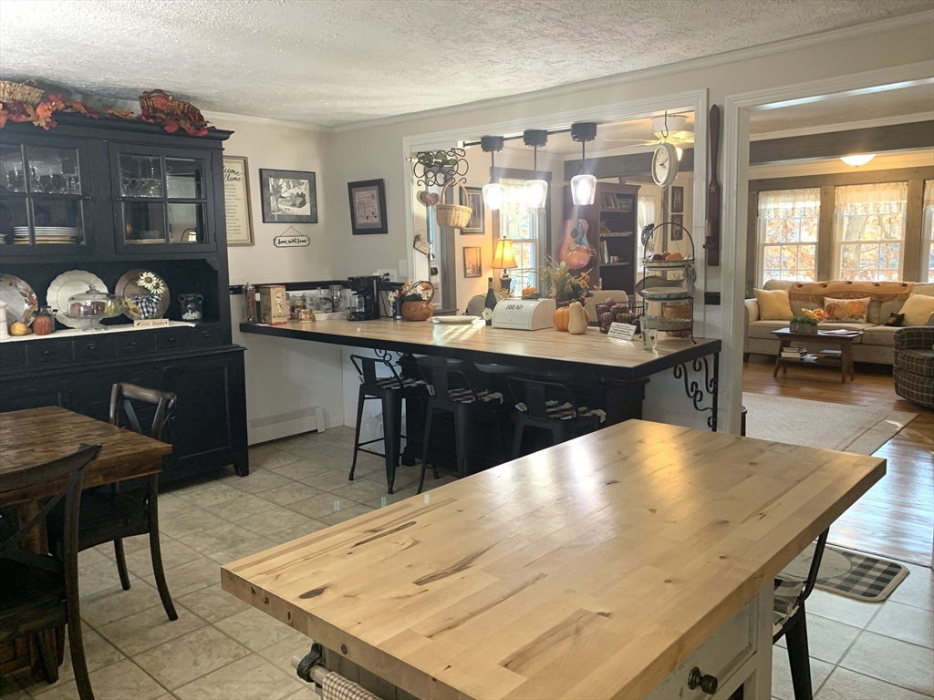 21 Sullivan Road Charlton, MA 01507 - Photo 9 of 35 a large kitchen with dining table and chairs