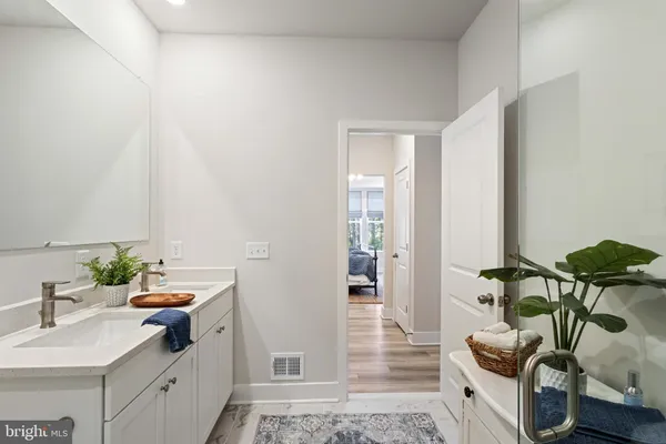 a room with furniture a rug and white walls